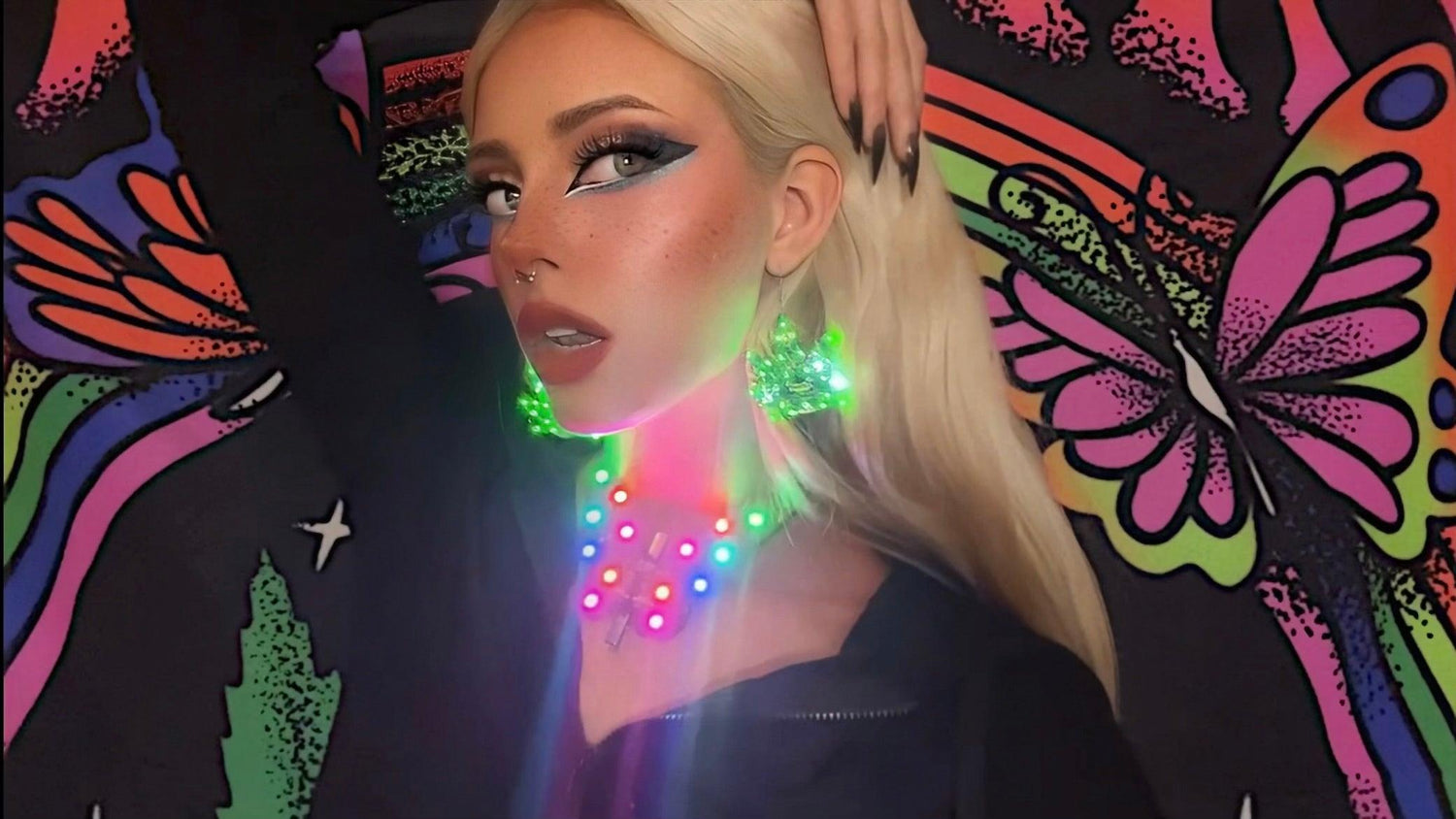Young woman wearing pot shaped LED earrings and a Butterfly-shaped LED necklace