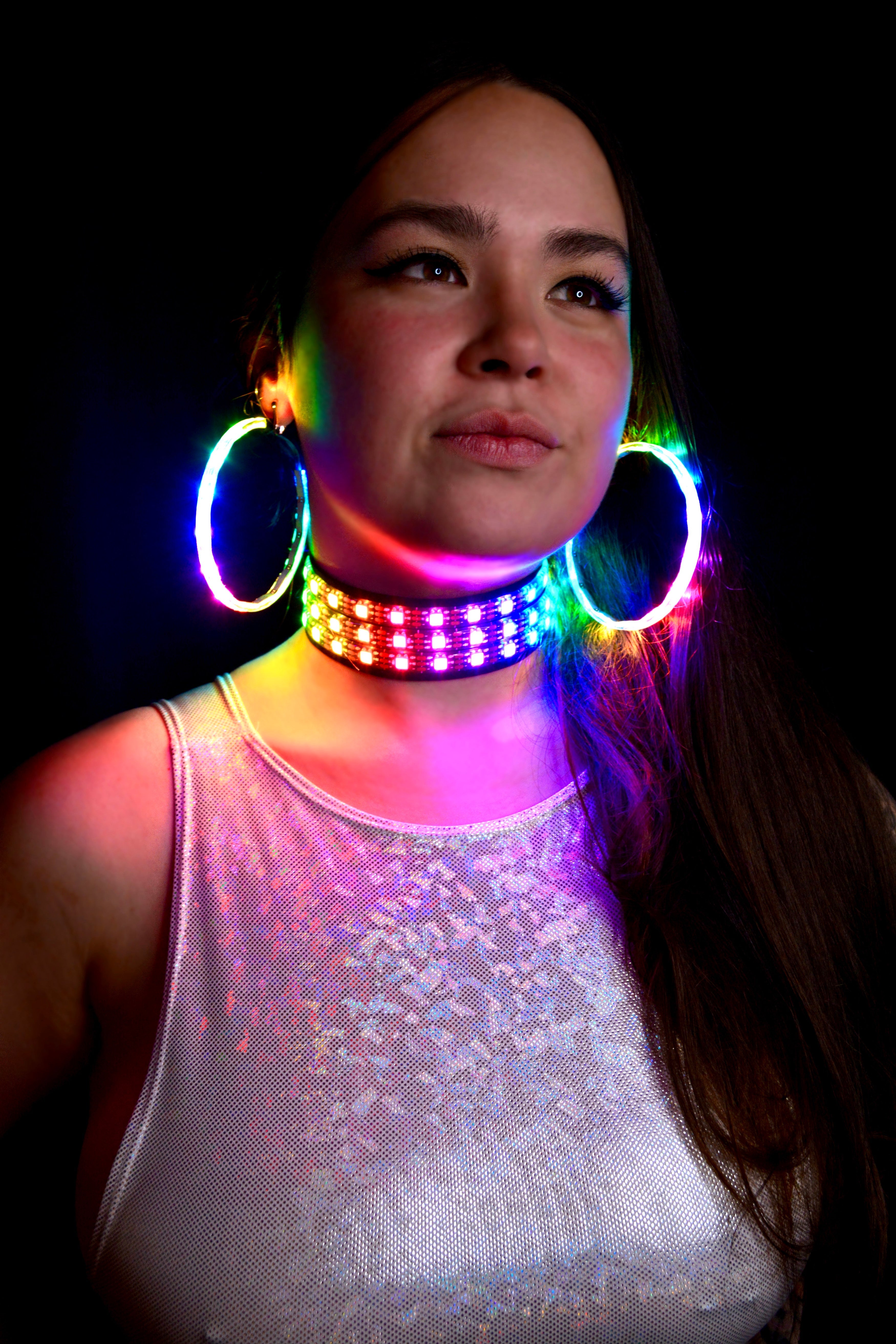 model wearing led choker and led earrings, posing with eyes up wearing a sparkly top